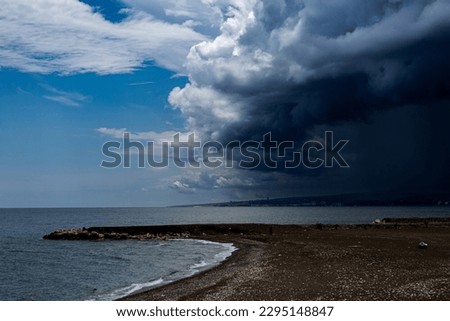 Storm clouds are coming. Sea, mountain, sky and beach views. Contrasting picture of the sky.