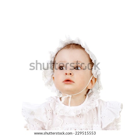 closeup image of the cute sweet little baby girl in the white dress and cap