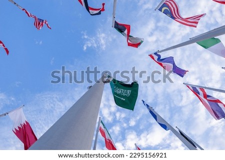 Doha, Qatar - April 25, 2023: Flags of countries in the old port of Doha, Qatar