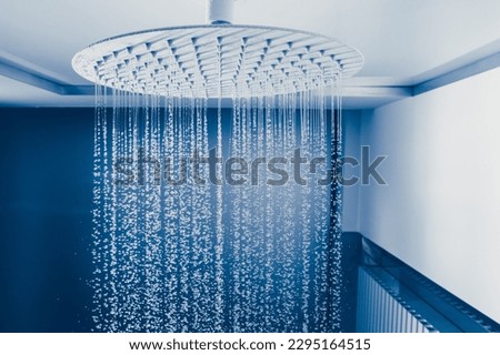 water drops falling from large rain shower head Royalty-Free Stock Photo #2295164515