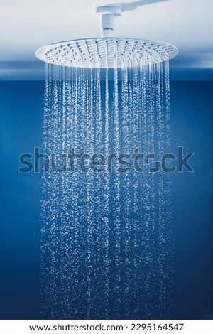 water drops falling from large rain shower head Royalty-Free Stock Photo #2295164547