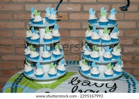 Individual Presentation Cupcakes Decorated With Whipped Cream; Baby Shower Theme