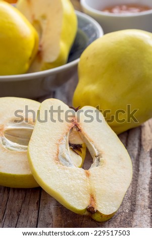 Quinces on a wooden background, sliced and whole. (Selective focus, small depth of field)