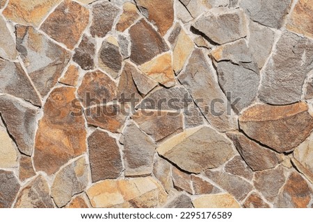 It is colorful big stones in a wall. The background is unfocused with art noise. This is a texture for designer.  Royalty-Free Stock Photo #2295176589