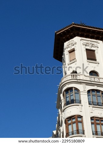 Rounded corner of old classical building in the center of Zaragoza, Spain. Vertical photo. Round forms of retro spanish architecture.