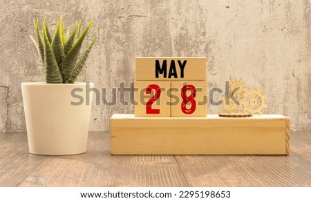May 28 calendar date text on wooden blocks with blurred nature background. Copy space and calendar concept