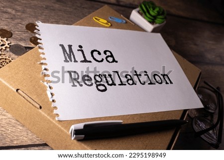 Markets in Crypto-Assets MiCA Regulation inscription on wooden blocks on dark background. Royalty-Free Stock Photo #2295198949