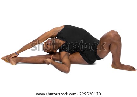male ballet dancer warming up and showing flexibility on white background