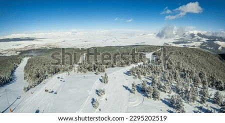 This breathtaking photo combines the stunning beauty of a mountain view with the thrilling adventure of a ski slope. Captured at a ski resort, this image showcases all the allure of winter activities 