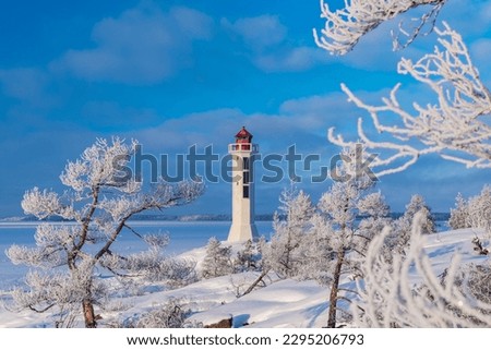 Winter Finnish lighthouse Kuninkaansaari (Povorotny), Vikhrevoy Island, Vyborg Bay, Gulf of Finland, Russia Royalty-Free Stock Photo #2295206793