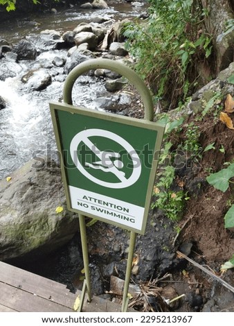 "no swimming" warning signs in outdoor parks