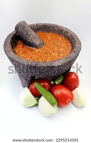 molcajete with red sauce, onions, chili peppers and tomatoes, mexican food, breakfastfood, mexican, Mexican cuisine   Royalty-Free Stock Photo #2295214101