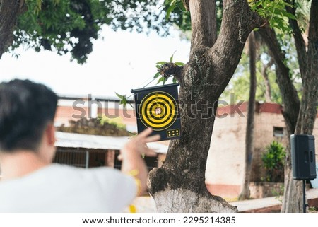 Young man casually practicing archery
Practicing archery outdoors: the relaxed approach of a young archer Royalty-Free Stock Photo #2295214385