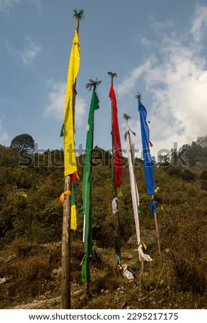 Multicolored prayer flags and beautiful green mountain in background. Selective focus. Royalty-Free Stock Photo #2295217175