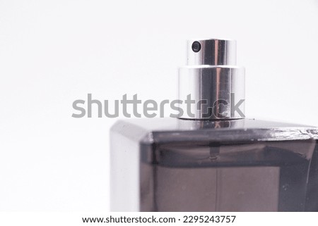 Black bottle of perfume or cologne with a silver label
