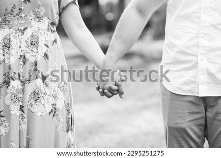 Young Couple Holding Hands Outdoors BW