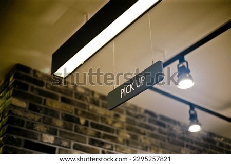 A sign that reads Pickup, which is common in restaurants, is usually hung on the ceiling so that anyone can easily recognize it