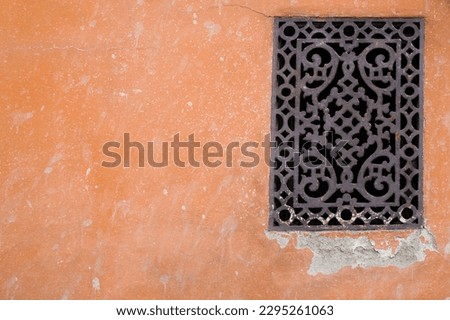 A beautiful vintage wrought iron design on the old wall background