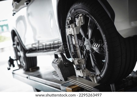 Car wheel alignment services in garage service shop.  Royalty-Free Stock Photo #2295263497