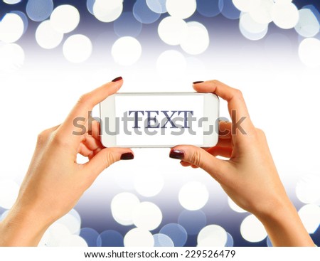 white smartphone over shiny background