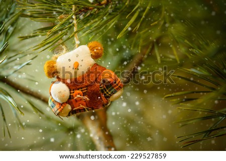 Toy Snowman In The Warm Clothing on The Christmas Tree