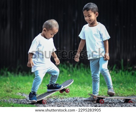 Little boy on skate board.