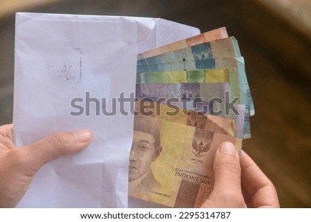 looks at the means of payment in Indonesia. Indonesian money is called rupiah. used as legal tender. not only to buy, money can also be used as a gift from other people.