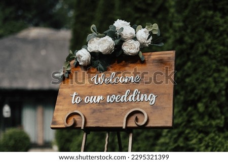 Welcome sign at the entrance to a wedding reception in the garden.