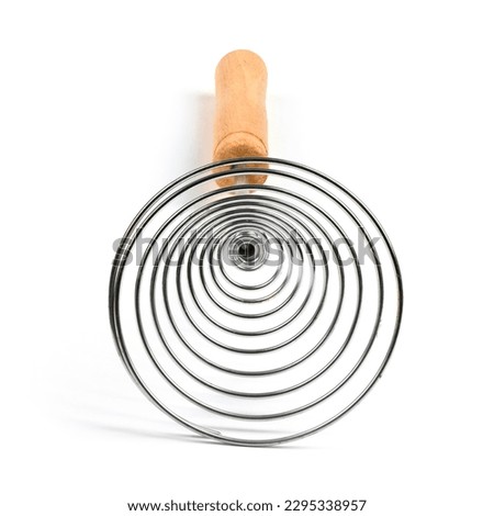 Close-up of old retro whisk kitchen tool on white background. Side view. High resolution photo. Full depth of field.