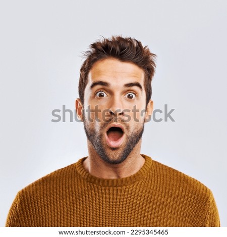 Shock, surprise and portrait of a man in a studio with an amazed facial expression or attitude. Shocked, amazing news and male model with a wtf, omg or wow face gesture isolated. by white background. Royalty-Free Stock Photo #2295345465