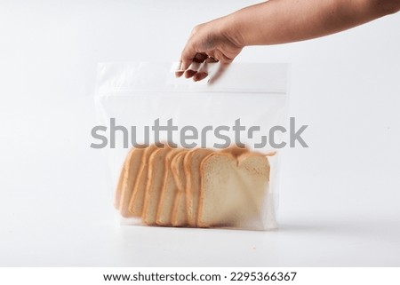 A man holding a mock up packaging of bread packaging in a solid clean white background. stock images and mock up bread packaging.