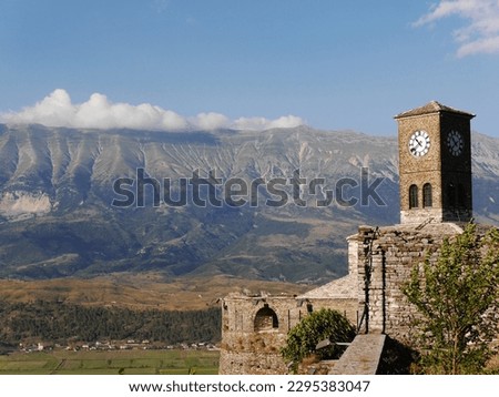 Gjirokaster Citadel with clock tower and view of mountains, Albania. High quality photo