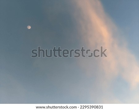 The moon on the sky with a cloud passing by