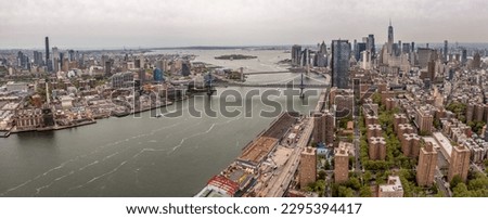 panoramic aerial Cityscape view of Manhattans Lower Eastside with Manhattan Bridge and Brooklyn Bridge across East River and Financial District and Brooklyn Skyline in the background 