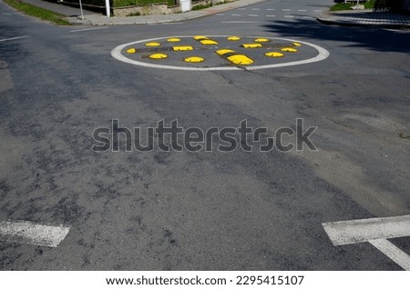 horizontal road marking lanes. highway concrete barriers on the road. vehicle collision lane separator. yellow color with black stripes. the road roundabout  concrete barriers