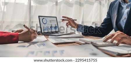 Two business people talk project strategy at office meeting room. Businessman discuss project planning with colleague at modern workplace while having conversation and advice on financial data report Royalty-Free Stock Photo #2295415755
