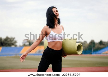 Picture of young fitness lady outdoors in the beach make yoga stretching exercises.
