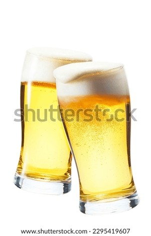 Beer, cheers, two glasses piled up Foam overflows from the glass Royalty-Free Stock Photo #2295419607