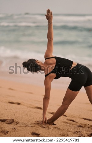 Beautiful girl doing yoga at the beach. High quality photo Royalty-Free Stock Photo #2295419781