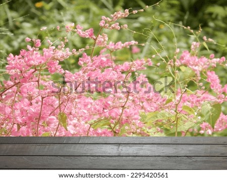 Photo of pink flowers on a wooden table