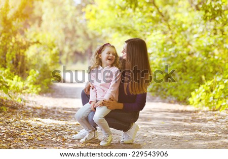Mother and child having fun outdoors in park