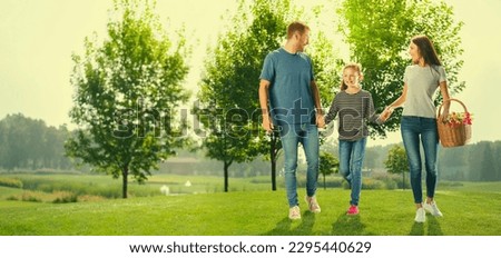 Portrait photo of wallking at picnic cheerful family, outdoors. Happy childhood and summertime concept. Copy space for ad text or slogan. Sunny day picture. Horizontal banner composition image.