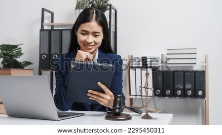 Young single female lawyer asian people in formal suit real estate working law book and contract documents, Arguments for Defense Strategy. Fight for Freedom. Supporting Evidence. Royalty-Free Stock Photo #2295450311