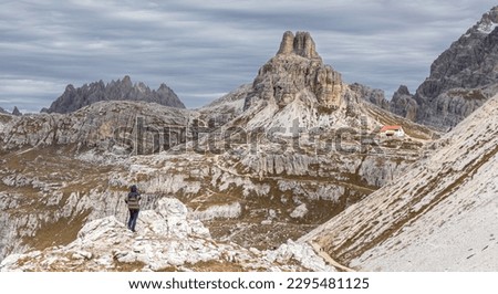 A tourist girl admires the beautiful landscape of the Italian Dolomites