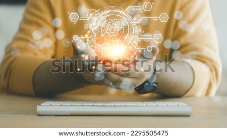 Man holding global network and brain icons with the idea of e-learning technology, online courses. AI and machine learning enhance personalized learning. online learning personal development concept Royalty-Free Stock Photo #2295505475