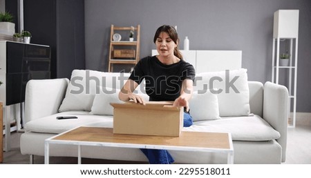 Woman Receiving Parcel Or Delivery Package. Opening Gift