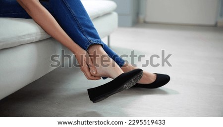 Uncomfortable Shoes Blister Pain. Woman With Sore Feet Royalty-Free Stock Photo #2295519433