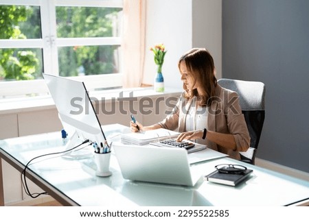 Professional Accountant Woman In Office Doing Accounting And Budget Royalty-Free Stock Photo #2295522585