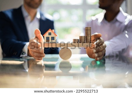 Real Estate House Money Equilibrium On Scale Royalty-Free Stock Photo #2295522713