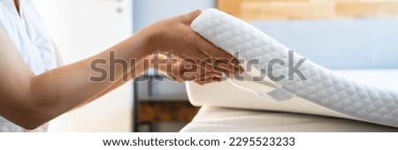 Mattress Topper Being Laid On Top Of The Bed Royalty-Free Stock Photo #2295523233